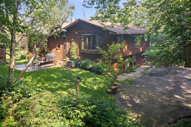 rear view of property featuring a yard