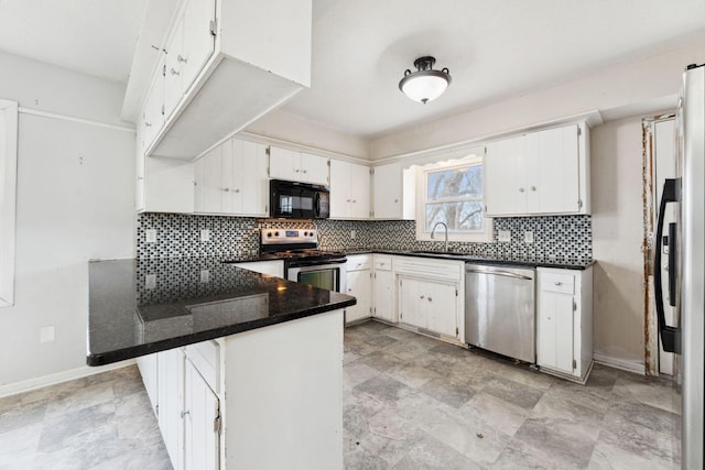 kitchen with a peninsula, appliances with stainless steel finishes, a sink, and decorative backsplash