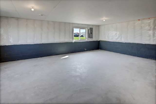 empty room with concrete block wall and concrete floors