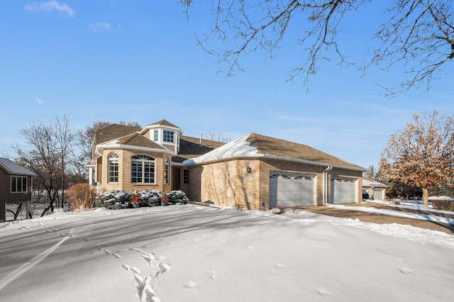 view of front of property with brick siding and an attached garage