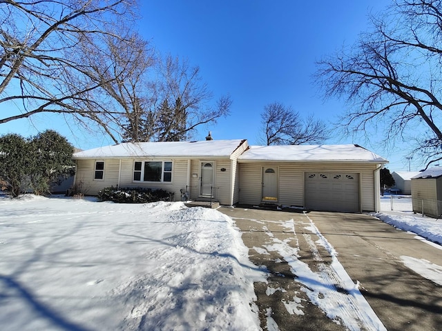 ranch-style house with a garage and concrete driveway