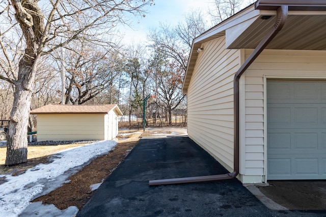 view of side of property with a garage and an outbuilding