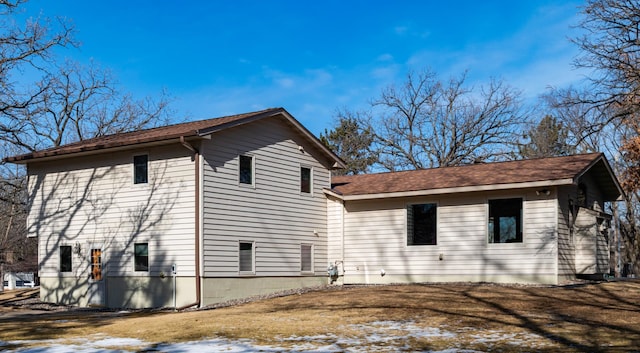 view of side of home featuring a lawn