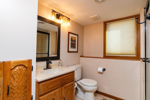 bathroom featuring toilet, visible vents, and vanity