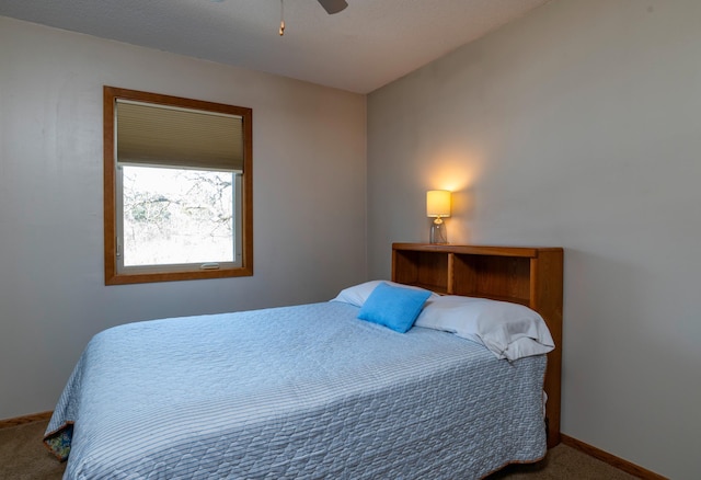 bedroom featuring ceiling fan, baseboards, and carpet flooring