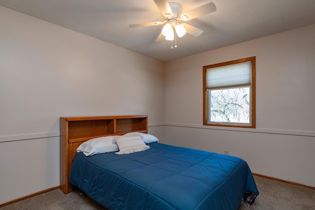 carpeted bedroom with a ceiling fan and baseboards