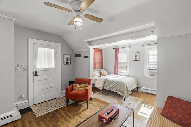 bedroom with ceiling fan, lofted ceiling, baseboard heating, and hardwood / wood-style floors