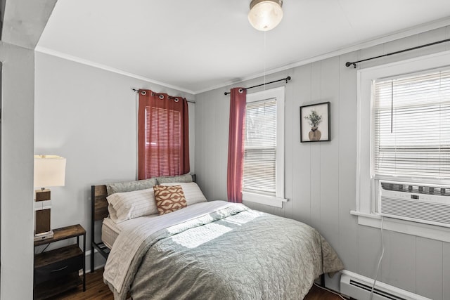 bedroom with a baseboard radiator, cooling unit, wood finished floors, and ornamental molding