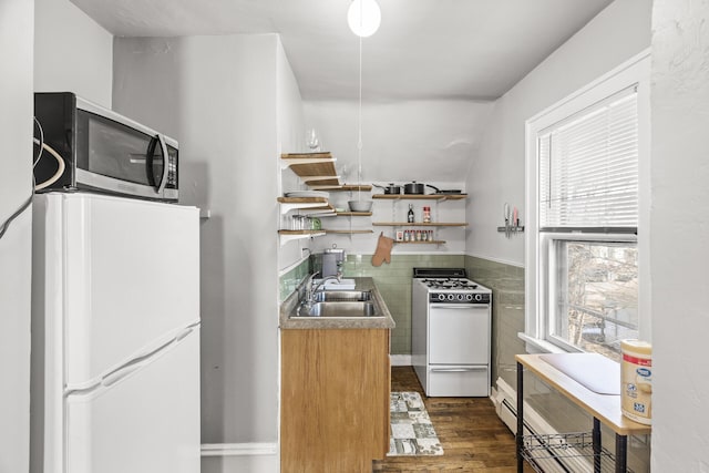 kitchen with white appliances, dark wood-style flooring, open shelves, and a sink