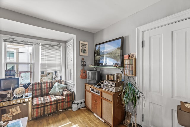 living area featuring light wood-type flooring and a baseboard radiator