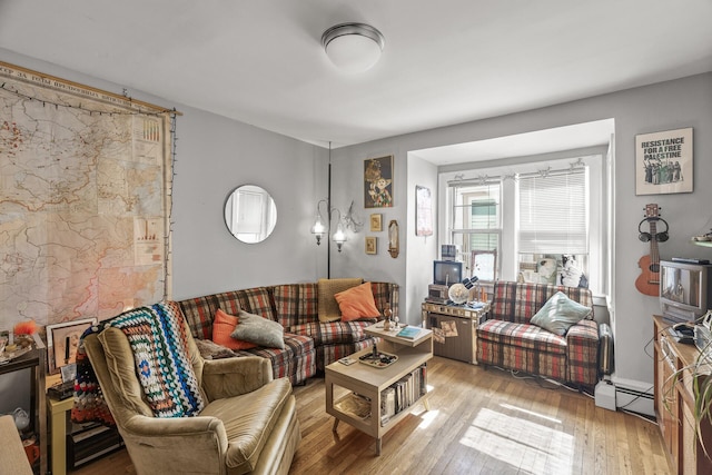 living area featuring baseboard heating and wood finished floors