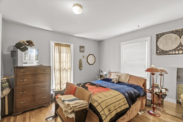 bedroom featuring baseboard heating and light wood-type flooring