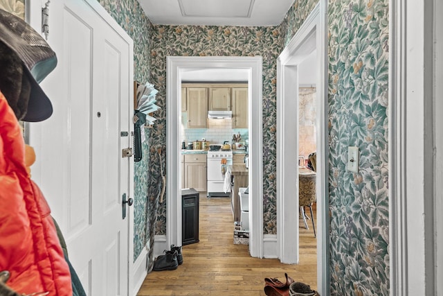 entryway featuring wallpapered walls and wood finished floors