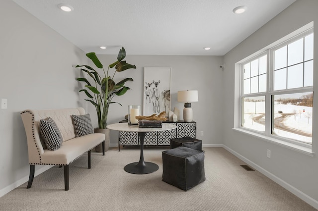 living area with carpet, visible vents, baseboards, and recessed lighting