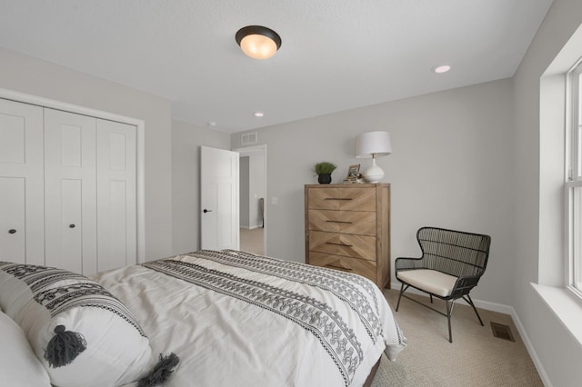 carpeted bedroom featuring recessed lighting, a closet, visible vents, and baseboards