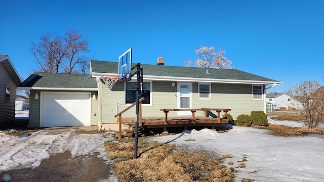 ranch-style house with a chimney and an attached garage