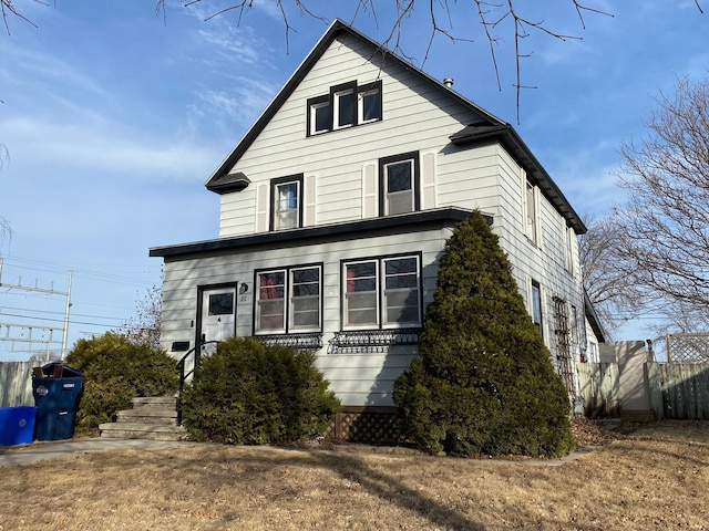 view of front of house featuring fence