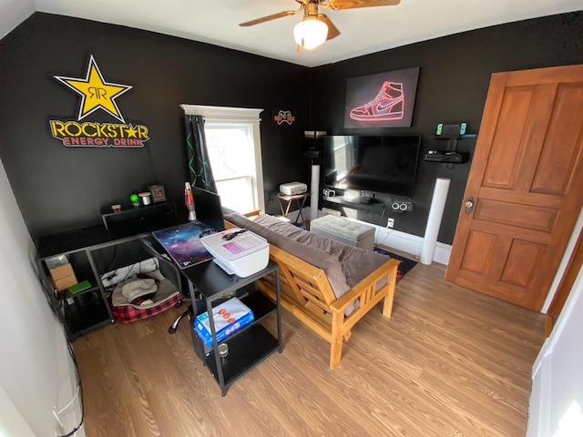 living room with wood finished floors and a ceiling fan