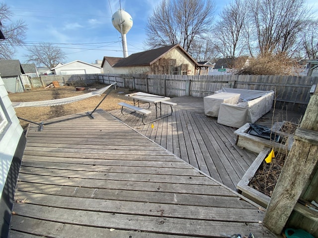 wooden deck with a fenced backyard