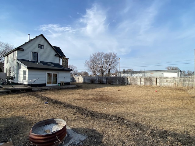 exterior space with a wooden deck and fence private yard