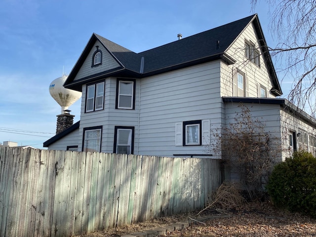 view of home's exterior with fence