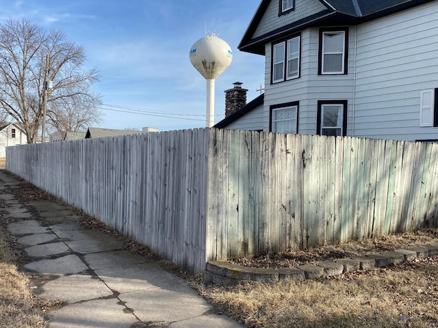 view of side of home featuring fence