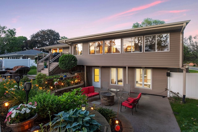 rear view of house featuring an outdoor fire pit, a patio, stairway, and fence