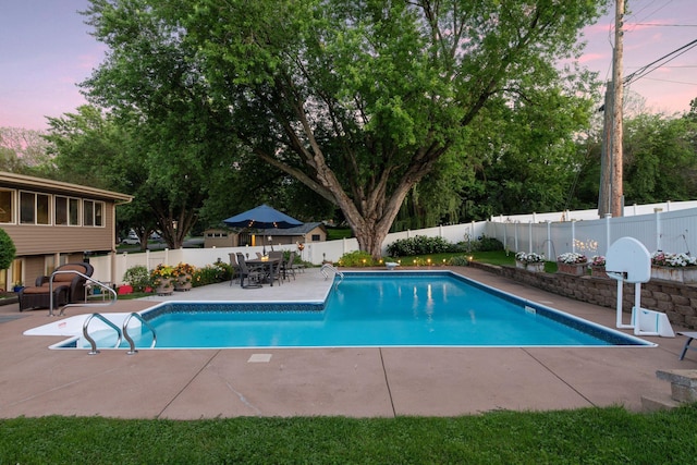 view of swimming pool featuring a patio area, a fenced backyard, outdoor dining area, and a fenced in pool