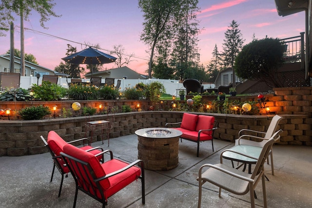 view of patio with an outdoor fire pit and fence