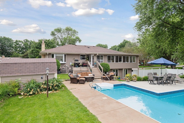 view of swimming pool featuring a fenced in pool, a patio, a sunroom, fence, and an outdoor living space