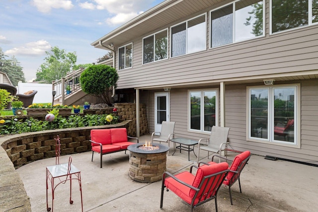 view of patio / terrace with an outdoor fire pit and stairs