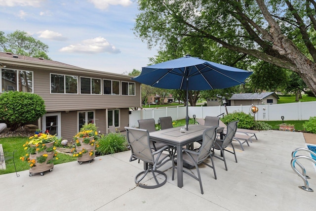 view of patio with outdoor dining area and a fenced backyard