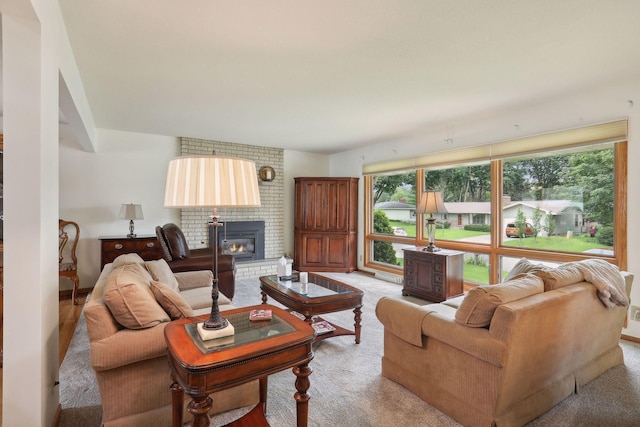 living area with light carpet and a brick fireplace