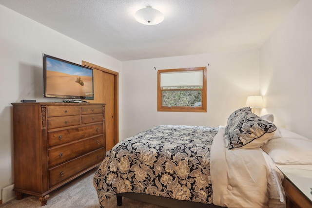 carpeted bedroom featuring a textured ceiling