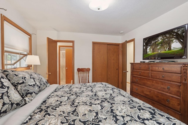 bedroom with a textured ceiling and a closet