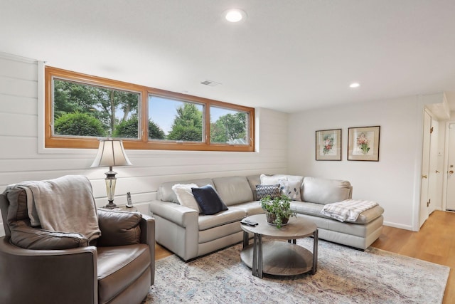 living room featuring light wood finished floors, visible vents, and recessed lighting