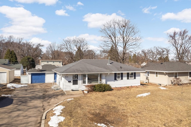 view of front of home featuring aphalt driveway, an outdoor structure, and entry steps