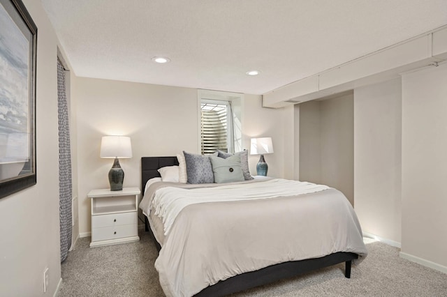 carpeted bedroom featuring recessed lighting and baseboards