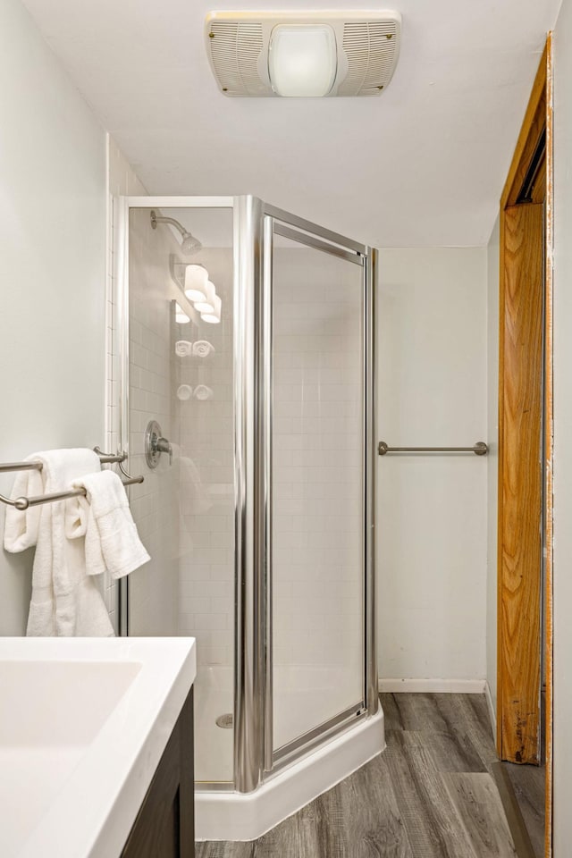 bathroom featuring visible vents, a stall shower, vanity, and wood finished floors