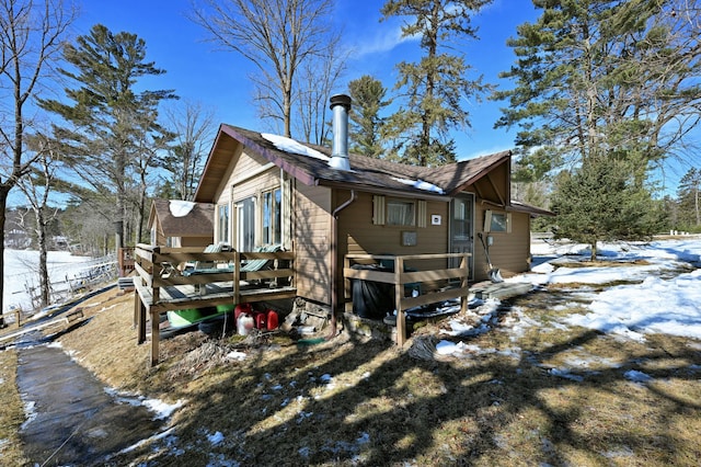 snow covered property featuring a wooden deck