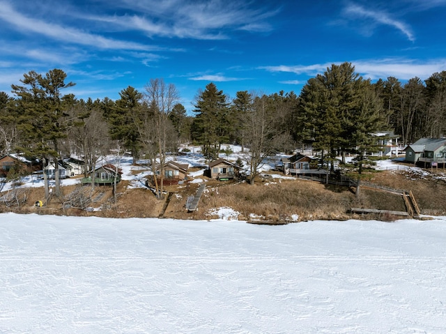 yard covered in snow with a residential view