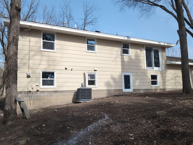 rear view of property featuring central AC