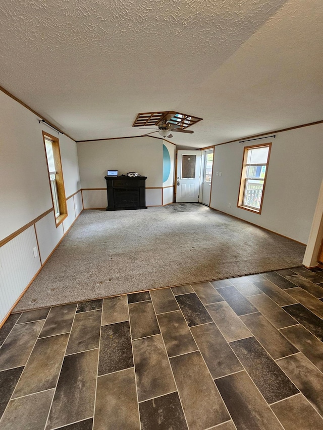 5 Orleans Ave, Inver Grove Heights, MN 55076 - unfurnished living room with a textured ceiling, ceiling fan, and a wainscoted wall