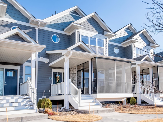 view of front facade featuring a sunroom and stairs