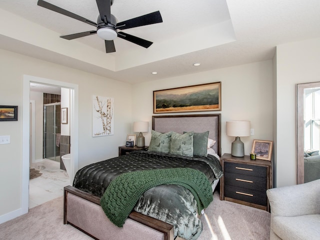 bedroom with baseboards, a raised ceiling, connected bathroom, a ceiling fan, and recessed lighting