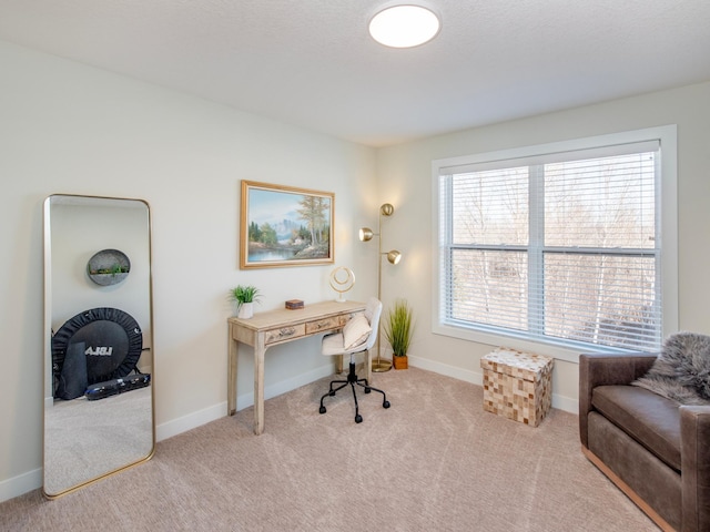 carpeted home office with baseboards