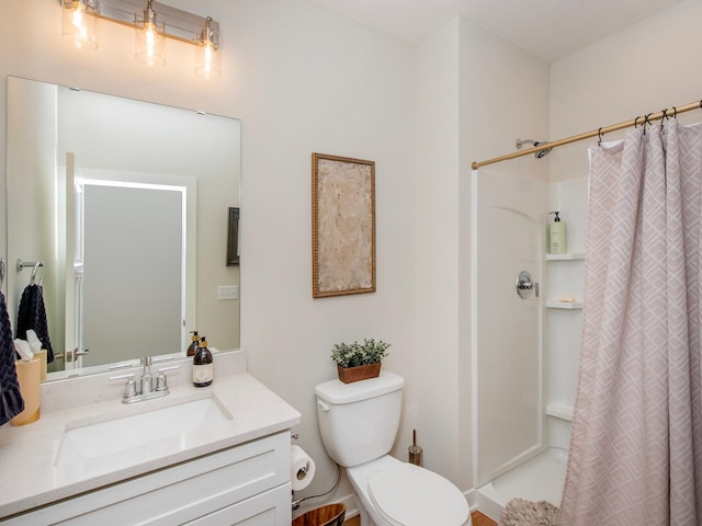 bathroom featuring toilet, curtained shower, and vanity