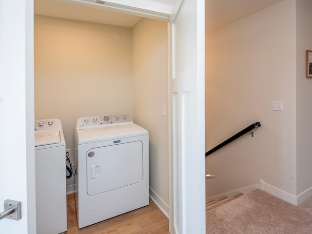 laundry area with laundry area, washer and clothes dryer, and baseboards