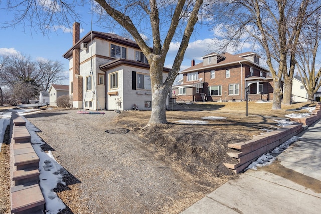 traditional style home featuring a residential view and a chimney