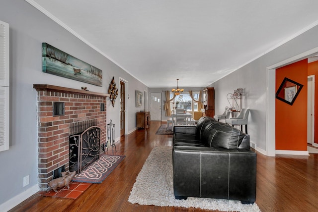 living area with dark wood-style floors, a fireplace, baseboards, and a notable chandelier